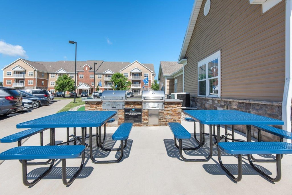 our picnic tables and grill are in front of our apartments with a large patio