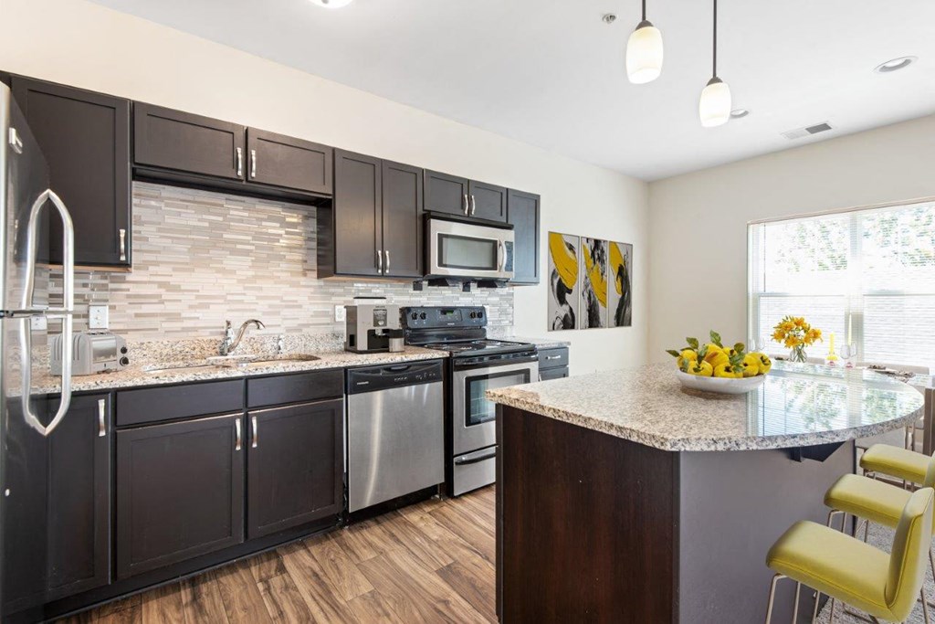 a kitchen with stainless steel appliances and granite counter tops