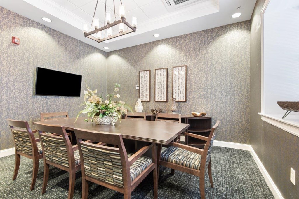 a dining room with a large table and chairs