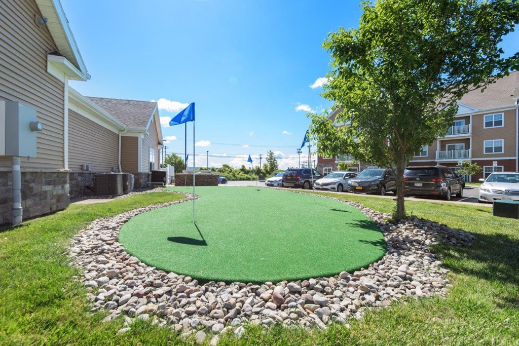 a putting green in the front yard of a house