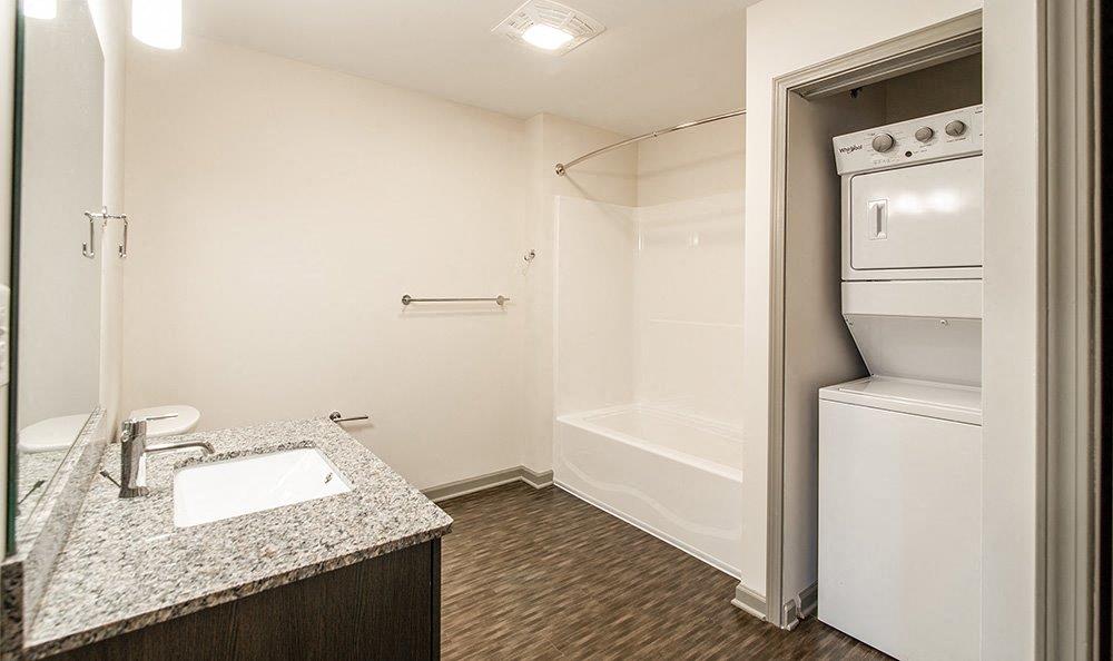 a small bathroom with a sink and a refrigerator