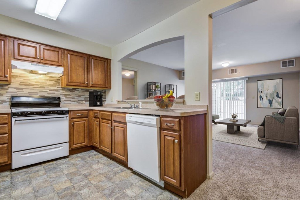 a kitchen with white appliances and wooden cabinets