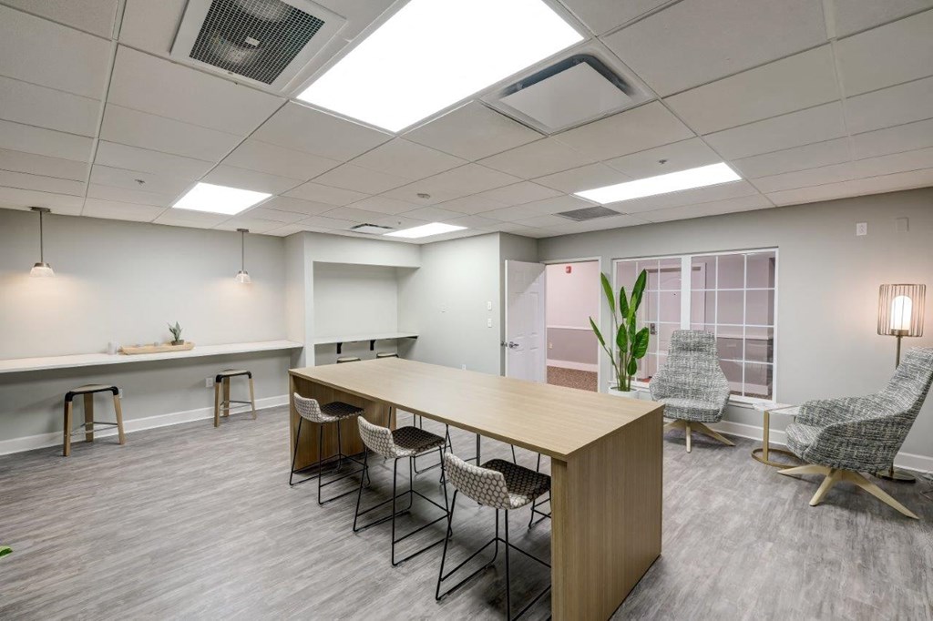 a room with a large table and chairs in it