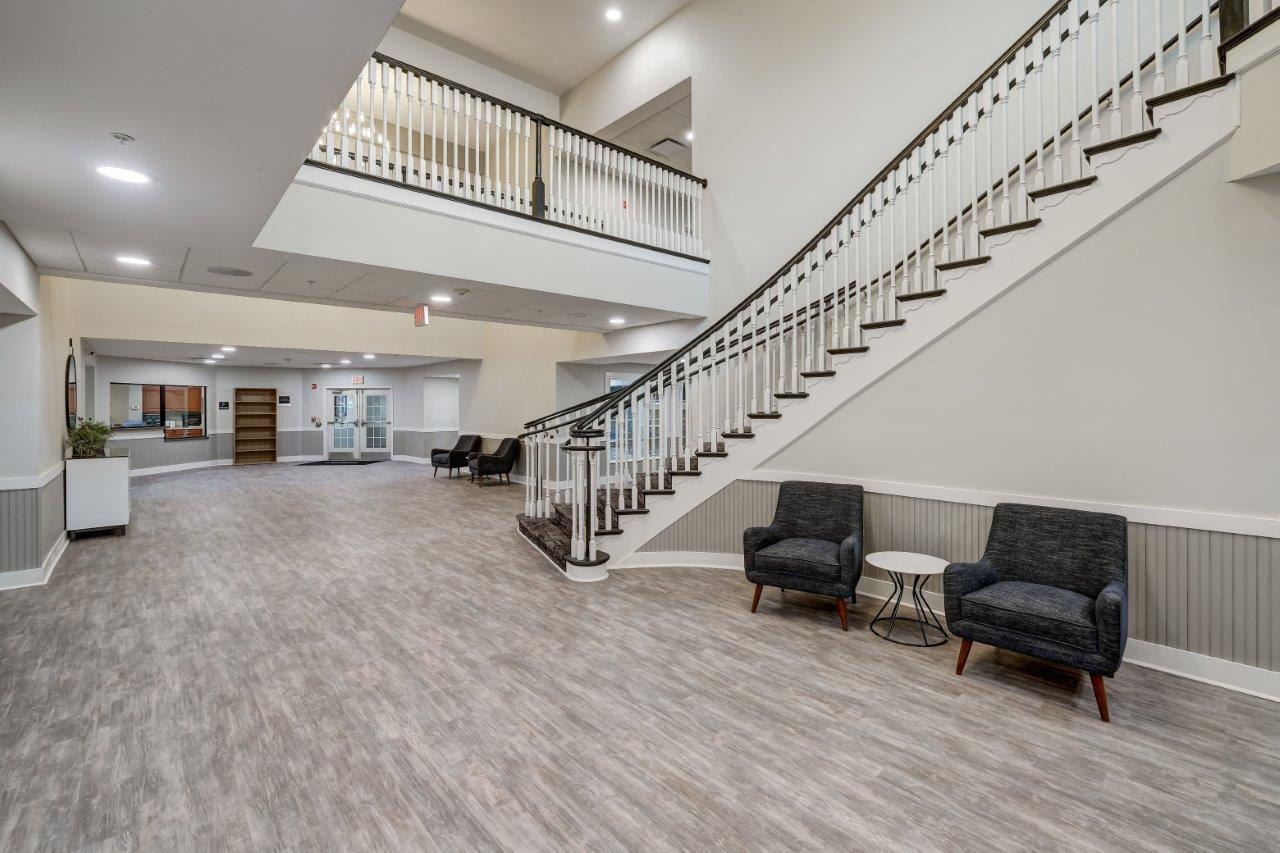 the lobby or reception area of a building with a staircase