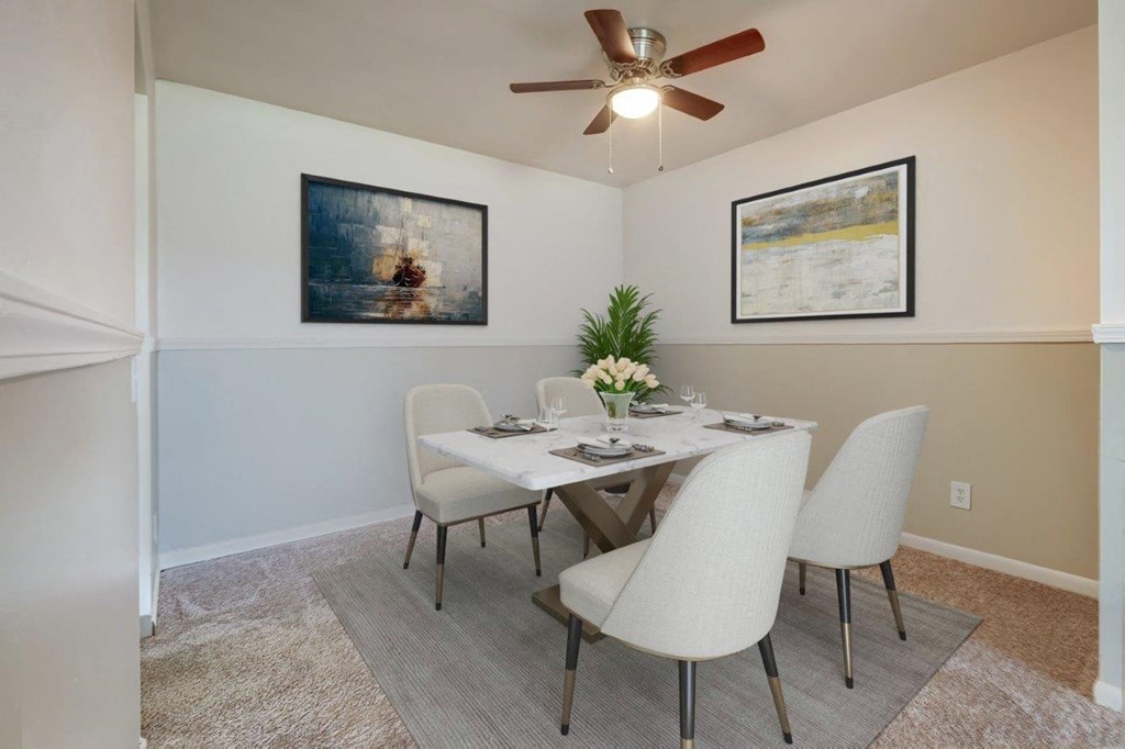 a dining room with a table and chairs and a ceiling fan