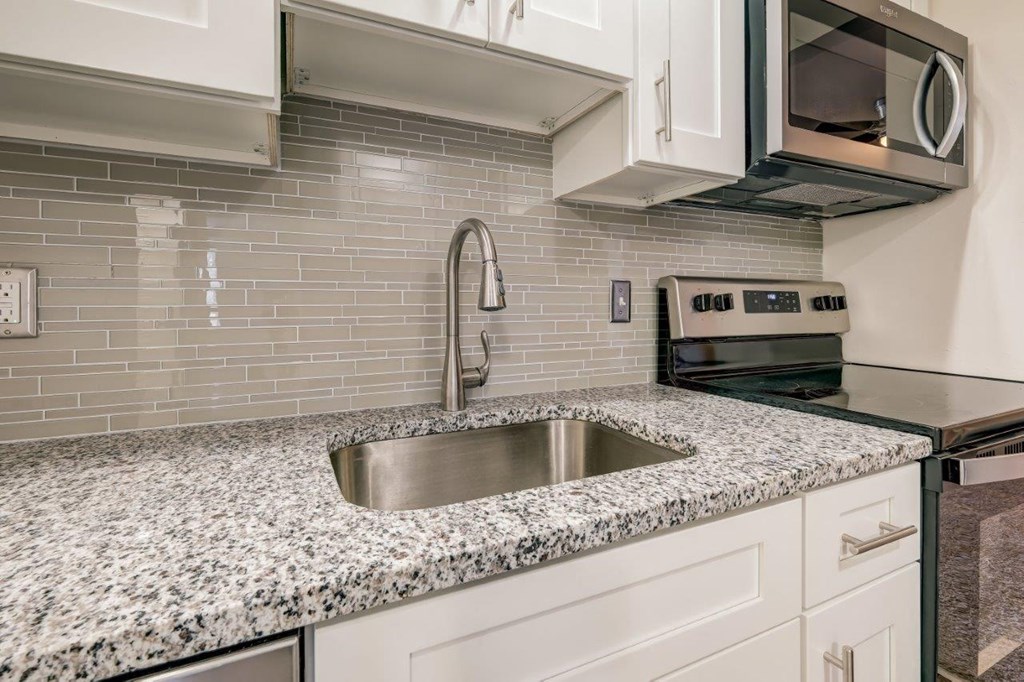 a kitchen with granite counter tops and a sink