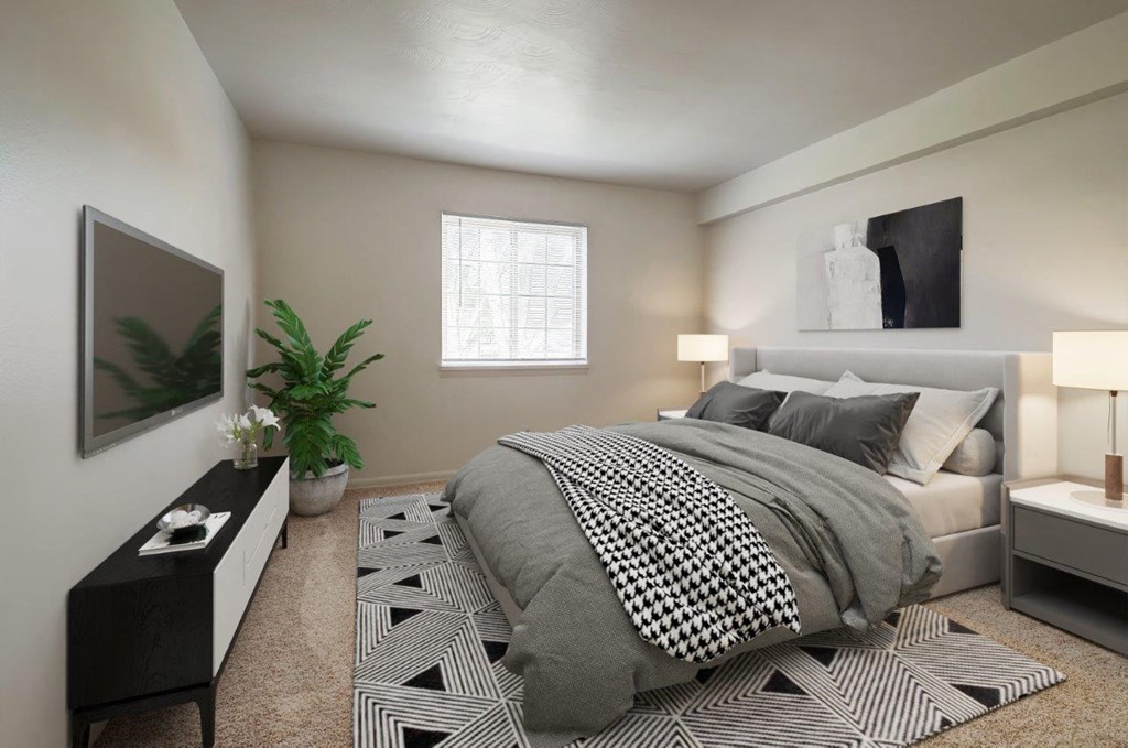 a bedroom with a bed and a large window