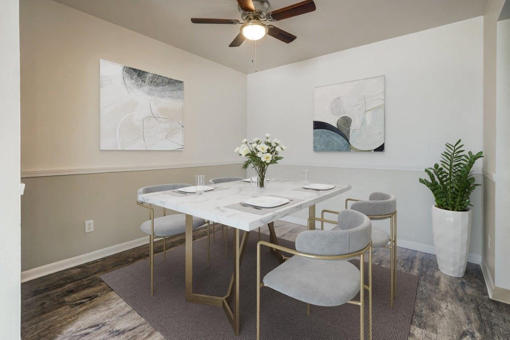 a dining room with a table and chairs and a ceiling fan