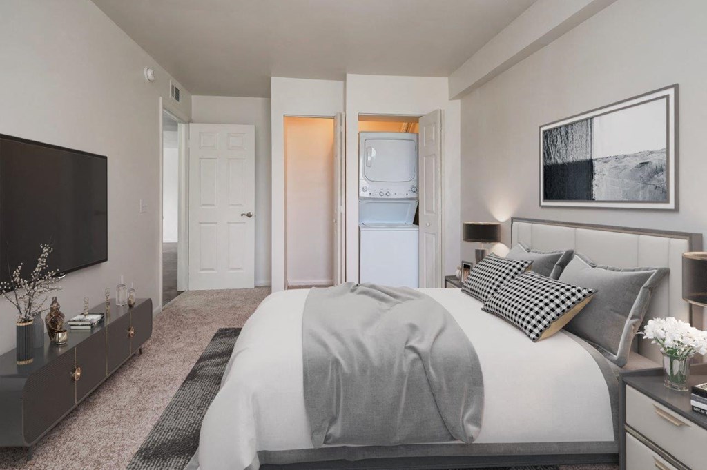 a bedroom with a large bed and a tv