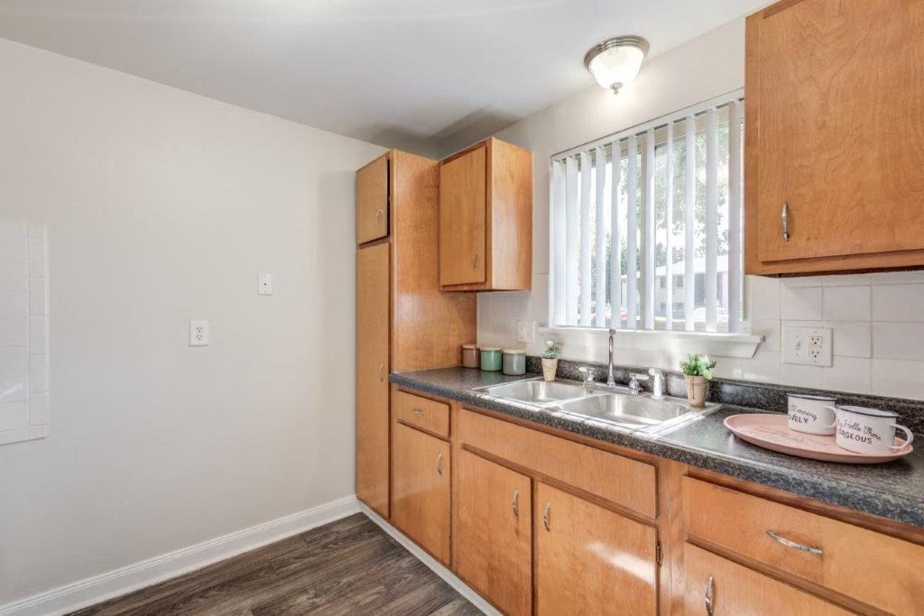 a kitchen with wooden cabinets and a sink