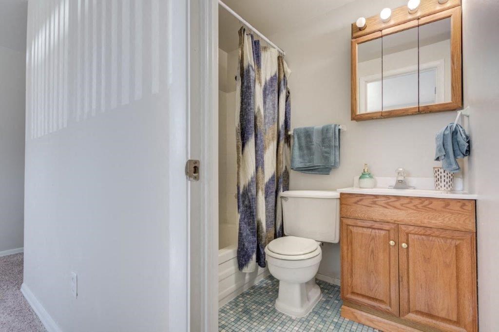 a bathroom with a toilet and a sink and a shower