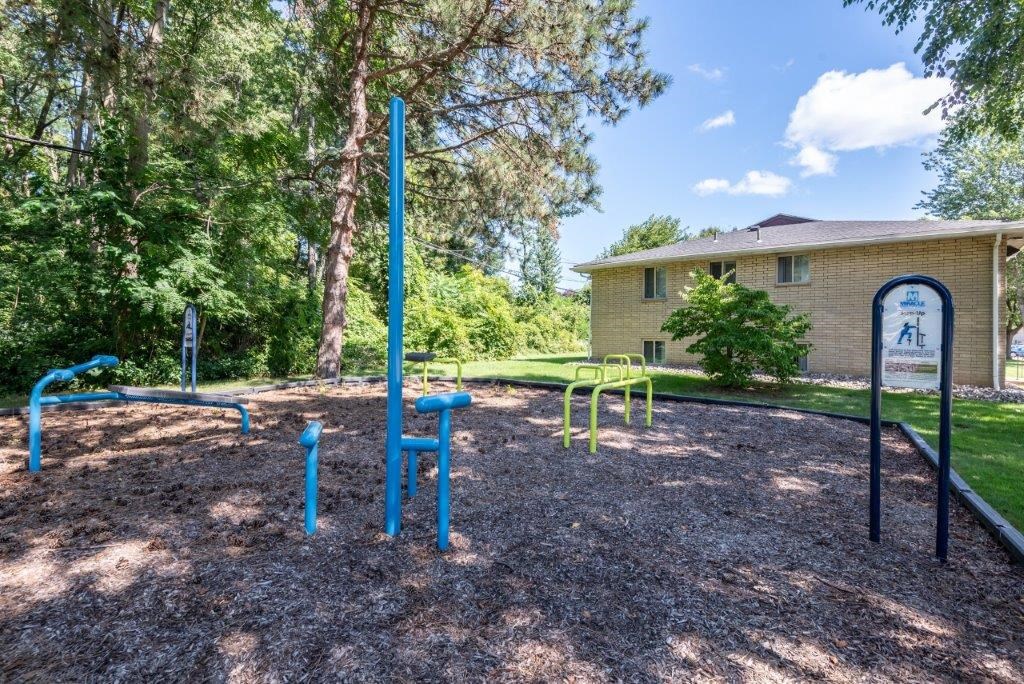 a park with a playground and a house in the background