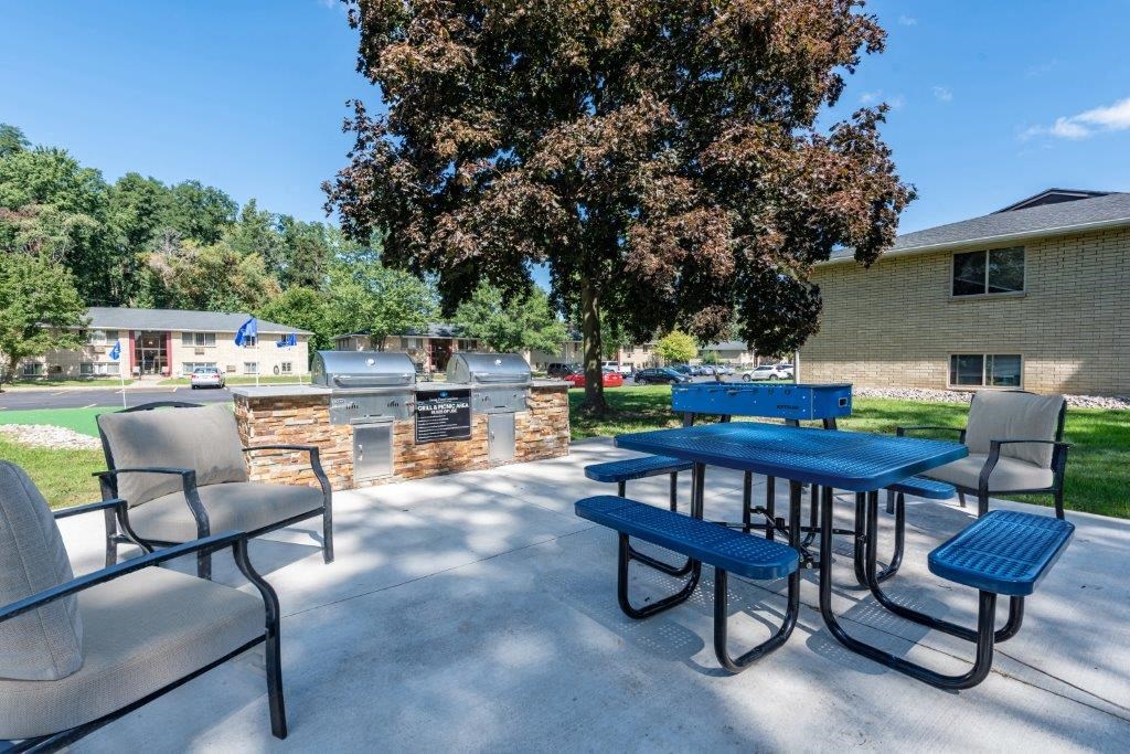 our outdoor patio has seating and picnic tables and a grill