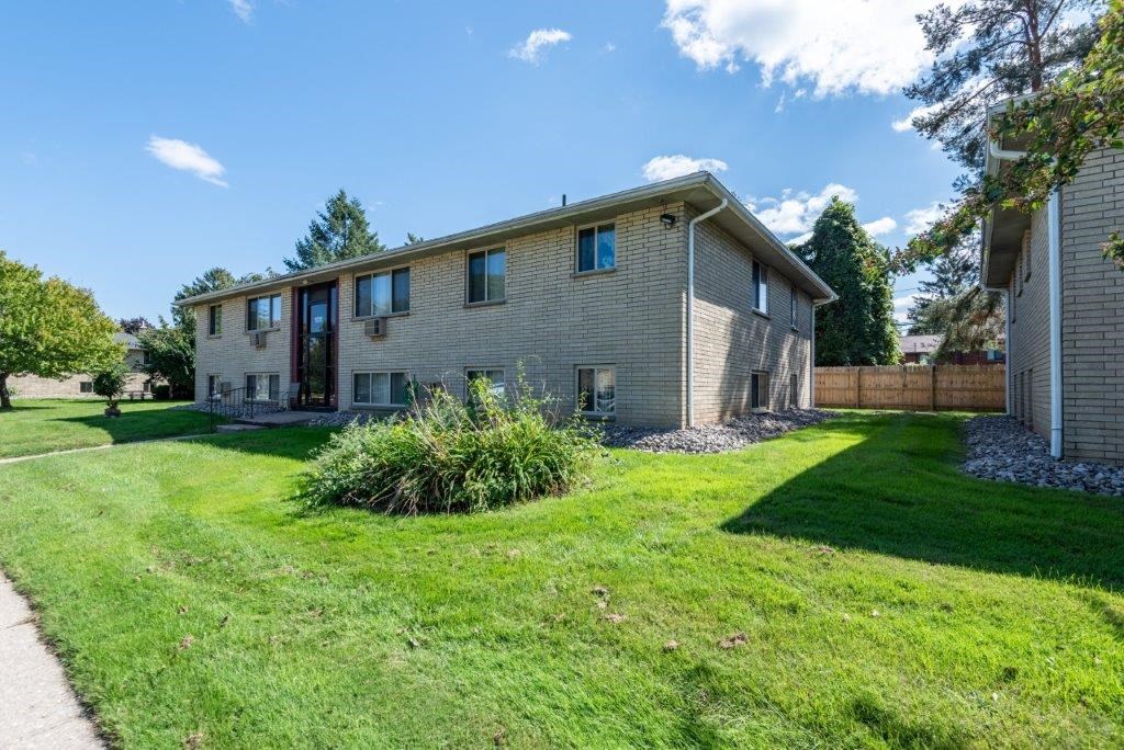 a white house with a yard and a sidewalk