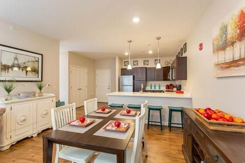 A dining room with a table set for a meal.