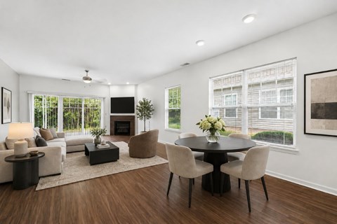 A modern living room with a fireplace and a dining table set up.