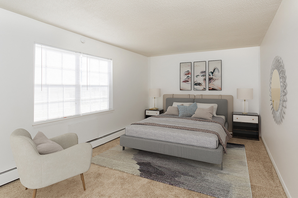 a bedroom with a bed and a chair and a window