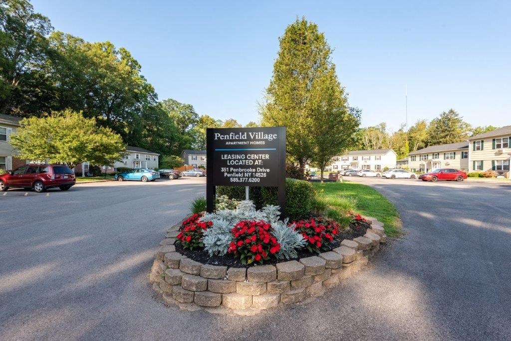 the park at village sign on the corner of a street