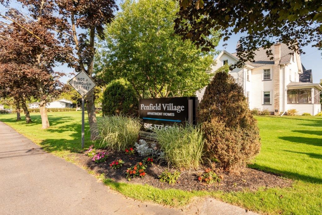 a sign for the randall village neighborhood in front of a house