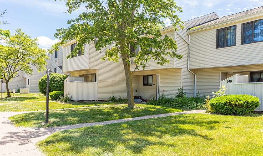 a white house with a tree in front of it