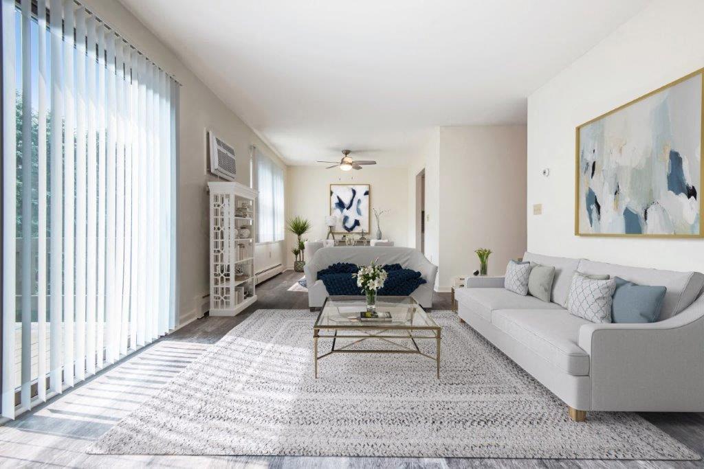 staged living area with vinyl plank floors and sliding door to patio