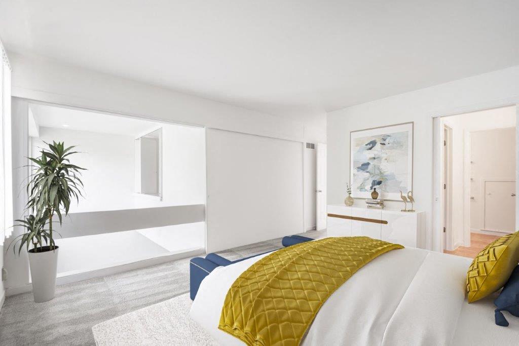 lofted bedroom with carpeting and an opening to below