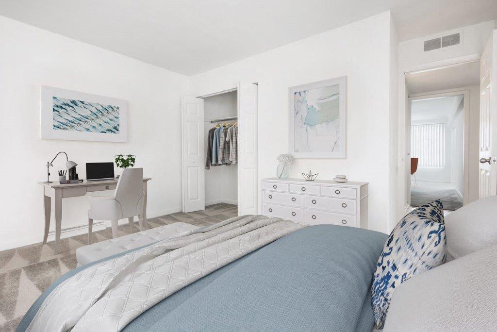staged bedroom with closet and carpeting