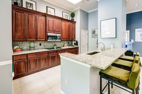 a kitchen with wooden cabinets and a counter top and a sink