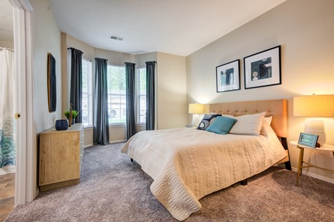 a bedroom with a large bed and a window