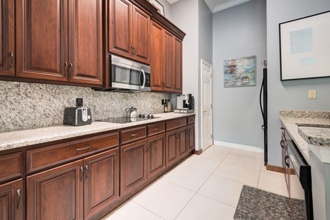 a kitchen with wooden cabinets and a sink and a microwave