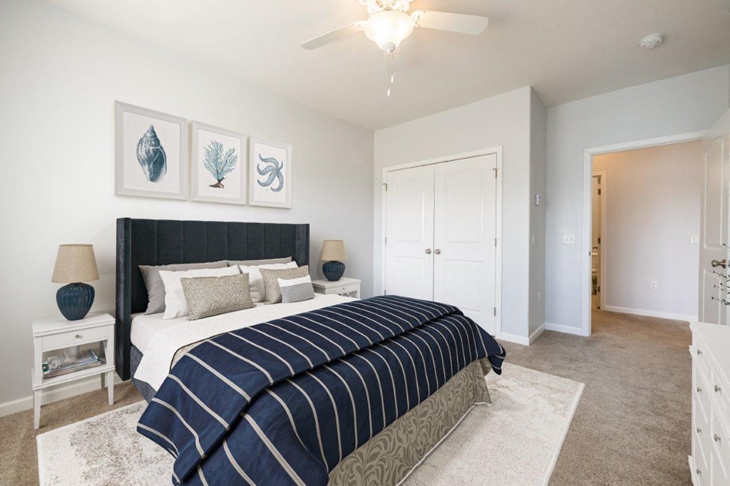 a bedroom with a bed and a ceiling fan