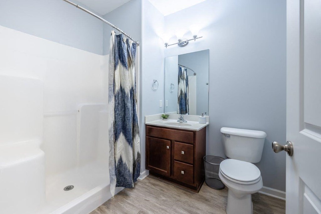 a bathroom with a toilet sink and shower