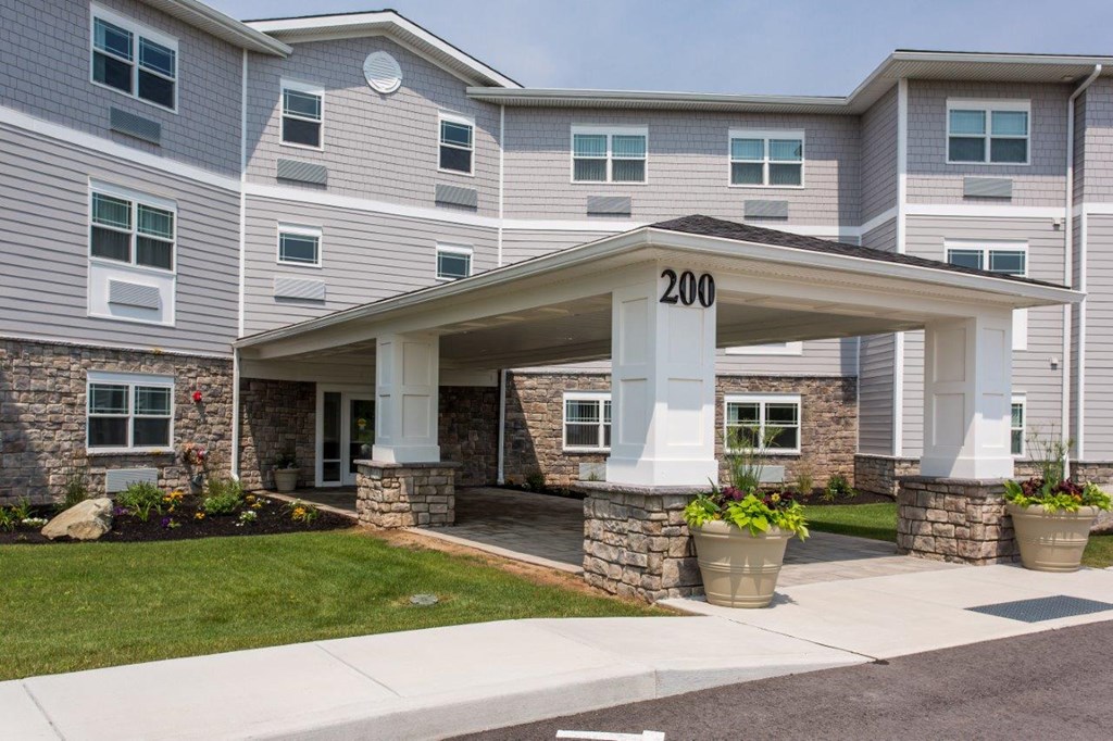 the front of a building with a porch and a number on it