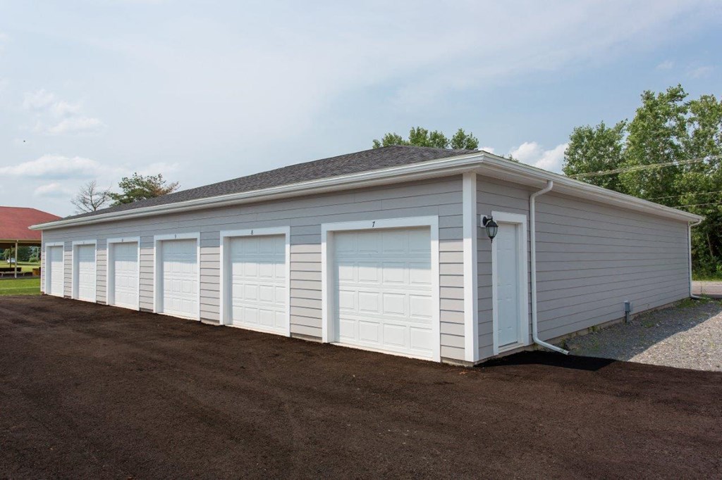 a white garage with a row of white garage doors