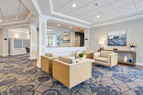 A spacious waiting room with patterned carpeting and a large painting on the wall.
