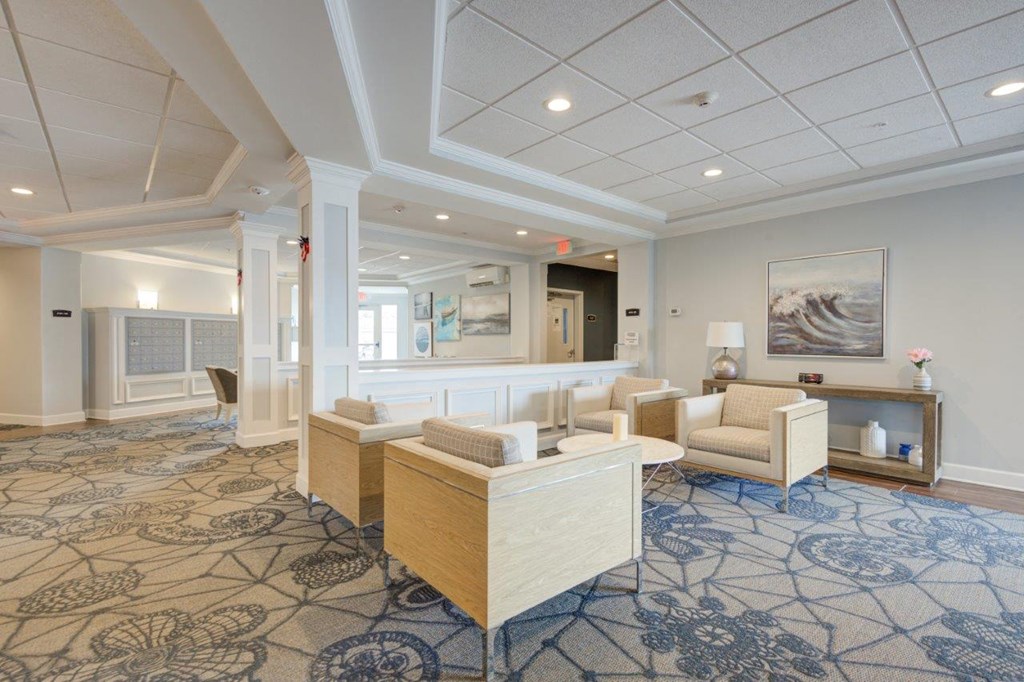 a lobby with couches and chairs and a fireplace