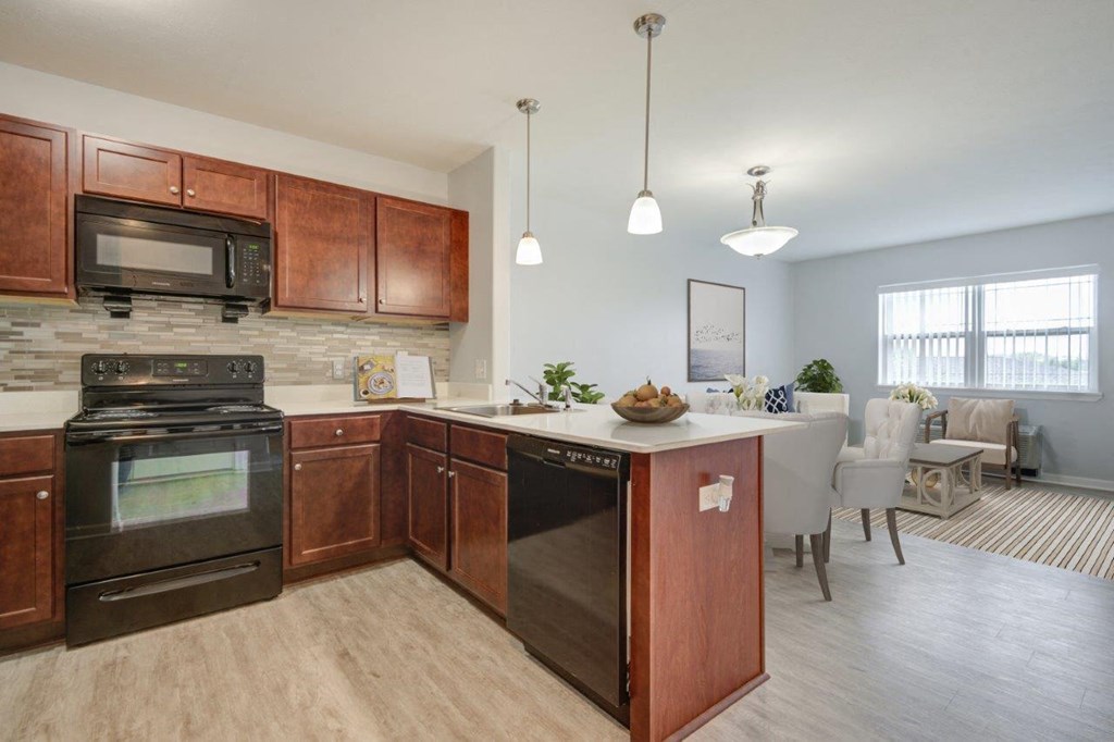 a kitchen with wooden cabinets and black appliances