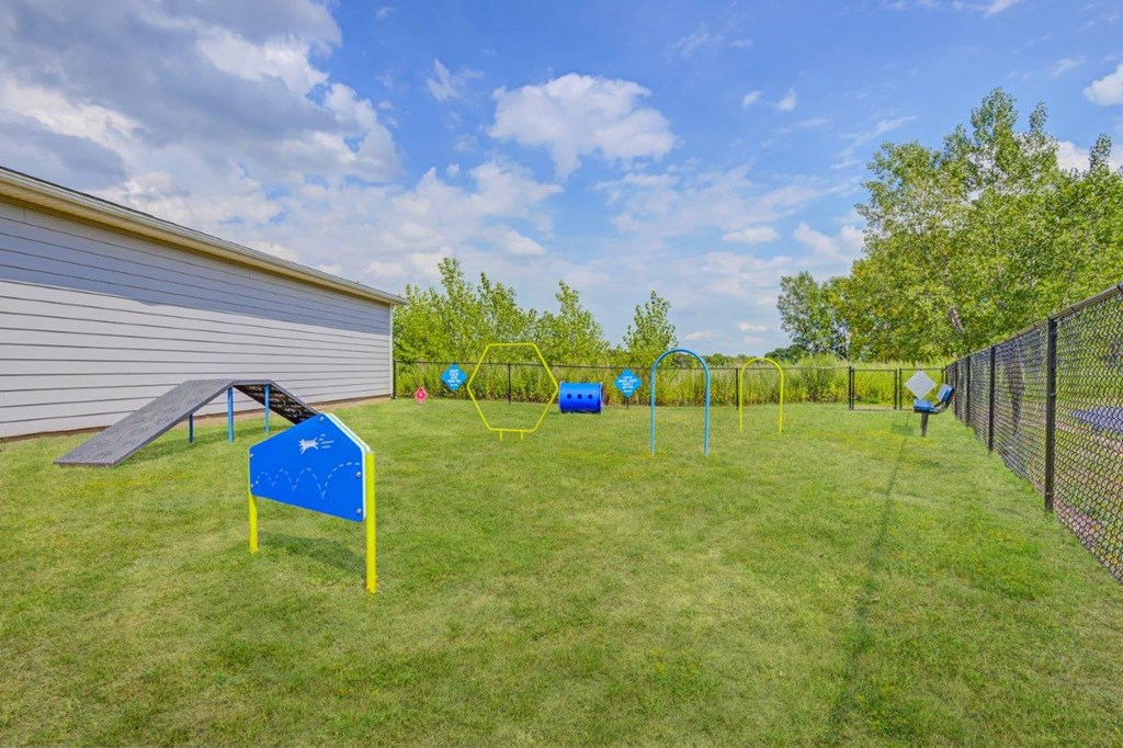 the backyard has a play area with basketball hoops and a volleyball court