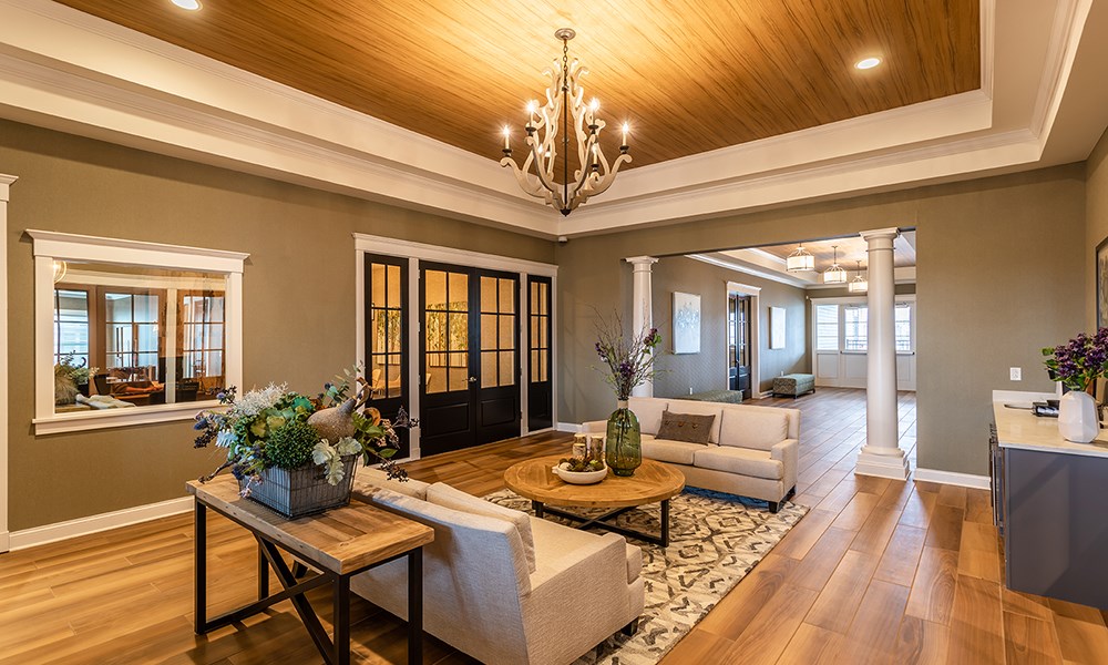 a living room with furniture and a chandelier