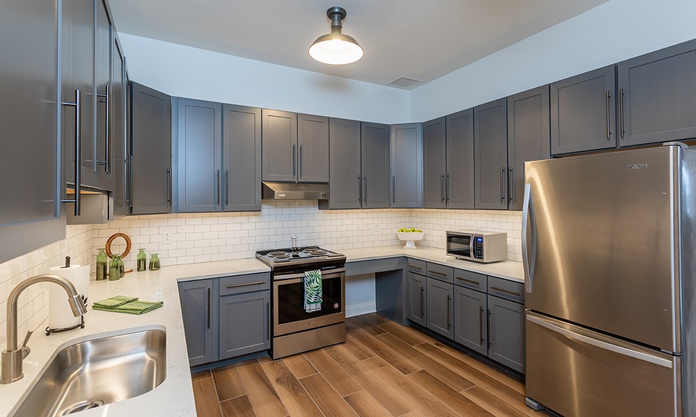 a kitchen with stainless steel appliances and gray cabinets