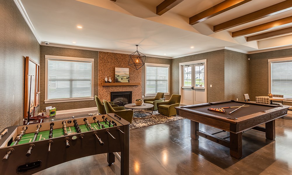 a game room with a pool table and a fireplace