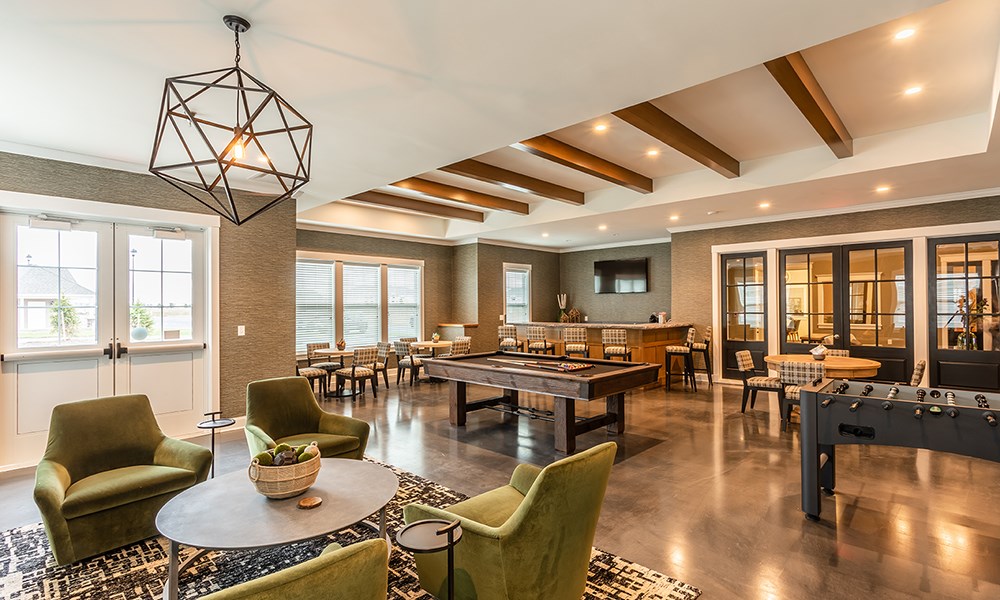 a game room with tables and chairs and a pool table