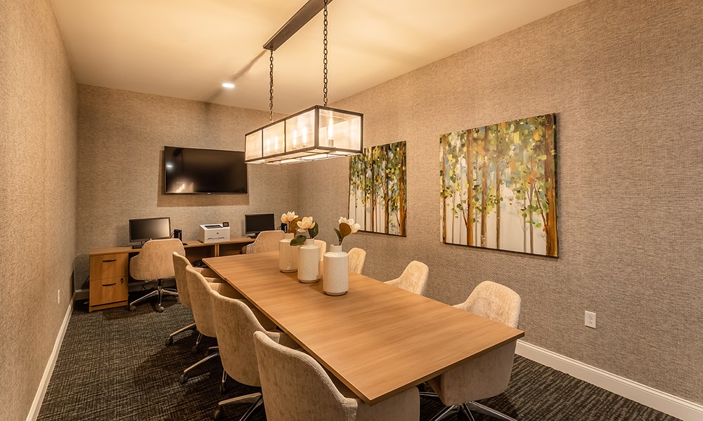 a conference room with a wooden table and chairs