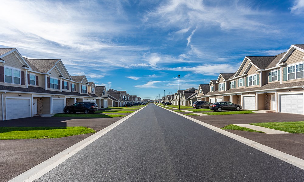 a street with rows of houses on either side of a road