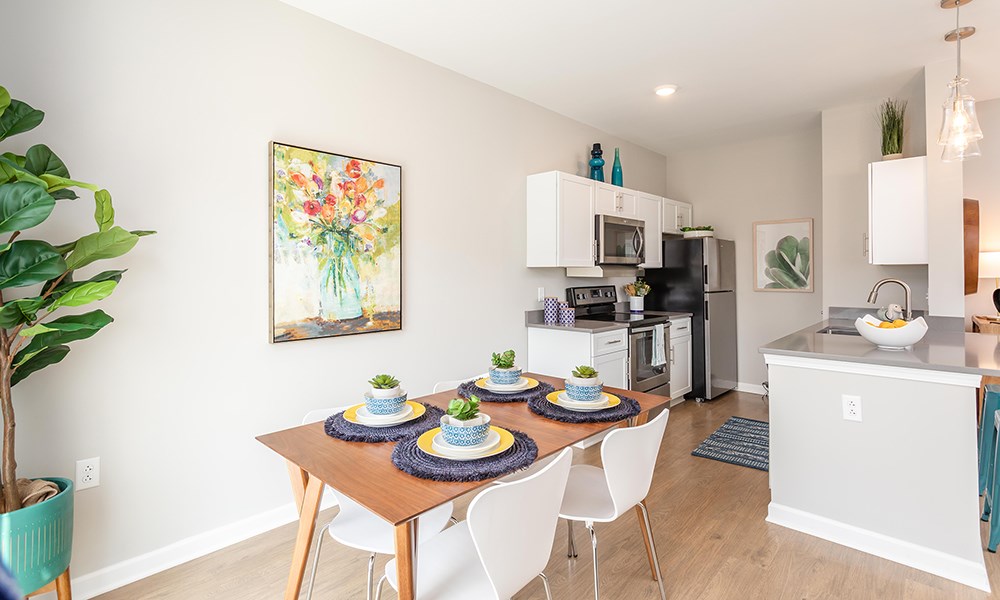 a kitchen and dining room with a table and chairs