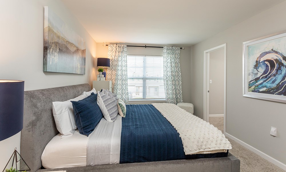 a bedroom with a large bed and a window