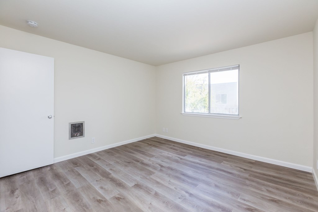 A room with a white door and a window with a white frame.