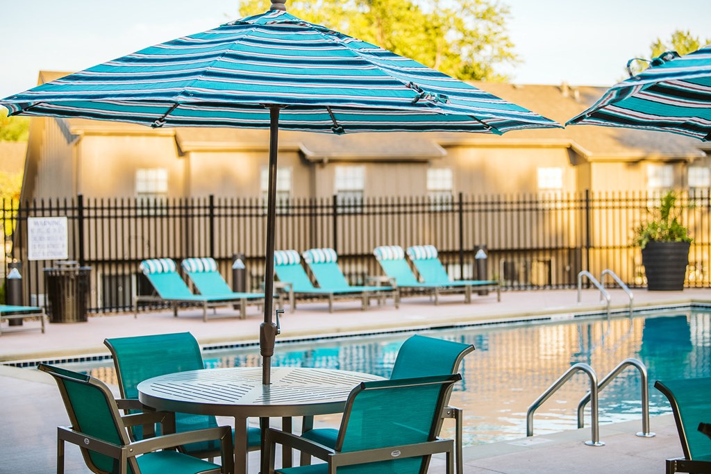 a pool with a table and chairs next to it