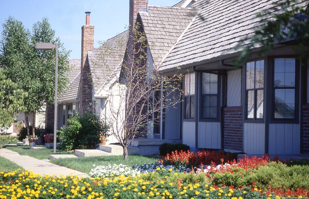 a row of houses with flowers in front of them