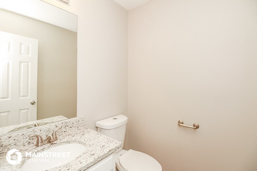 a bathroom with a sink and a toilet and a mirror